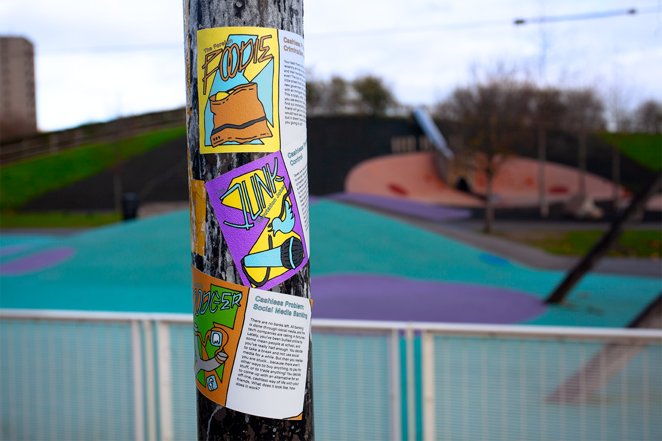 Planet cashless stickers stuck to a pole in a park